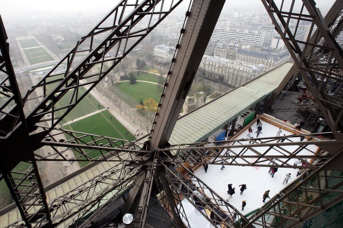 Paris, as seen through the lattice work of the Eiffel Tower. Jean-Patrick Manchette's novel "The Mad and the Bad" takes place, in part, in the city and is an example of French neo-polar noir.