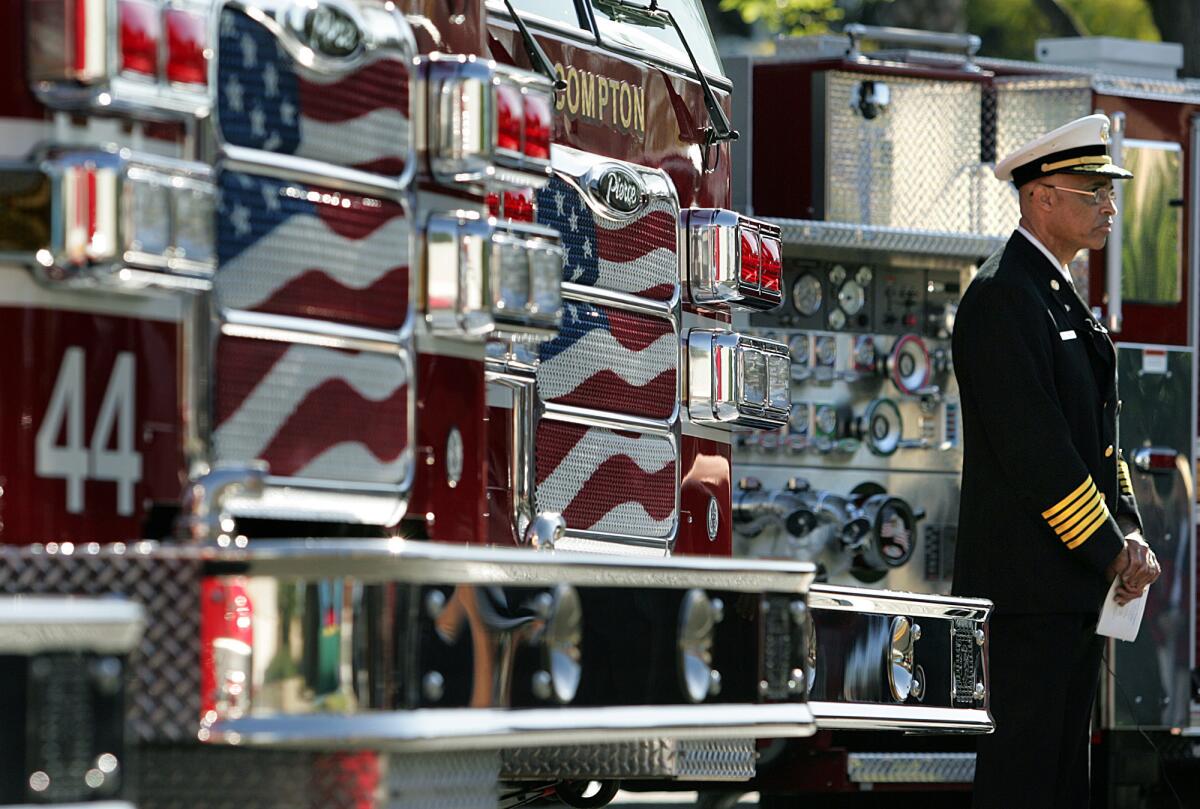 Engines from the Compton Fire Department on display during an unveiling in 2006. Former Fire Chief Rico Smith, right, left the force in 2007.