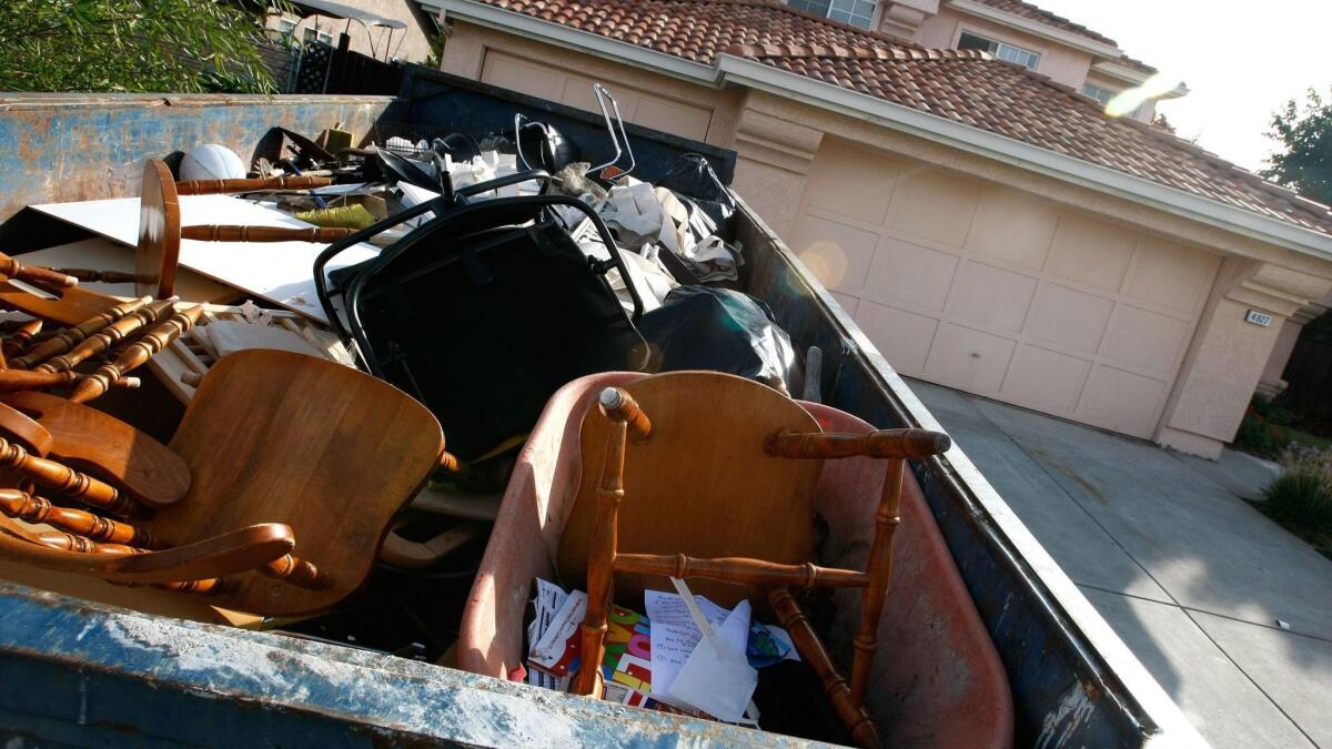 A dumpster is filled with furniture and personal property in front of a vacant home in Antioch in 2007.