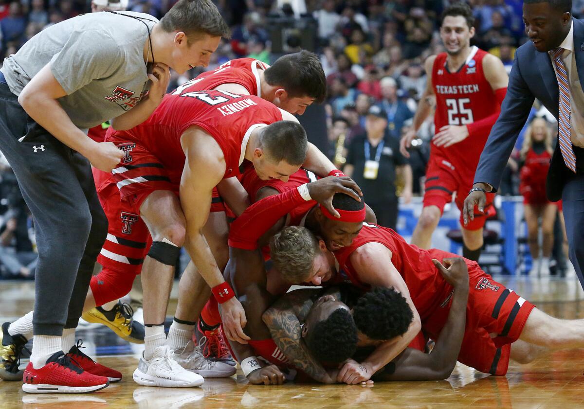 Texas Tech players celebrate after defeating Gonzaga, 75-69, in the NCAA tournament West Regional Final at the Honda Center