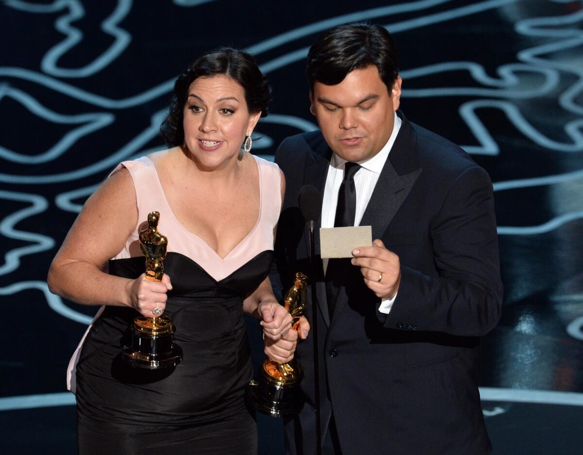 Songwriters Kristen Anderson-Lopez and Robert Lopez accept the original song award for "Let It Go" from "Frozen."