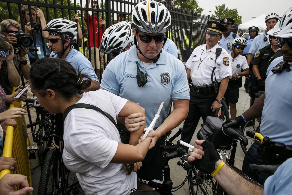 Protesters are detained as they cross a barrier set up by police outside the Democratic National Convention. (Marcus Yam / Los Angeles Times)