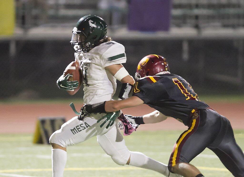 Costa Mesa High's Christian Villaverde runs into the end zone for a touchdown after a reception against Estancia.