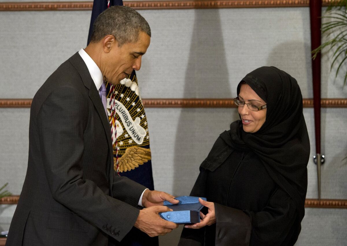 President Obama presents Dr. Maha Al Muneef, a human rights advocate, with the Secretary of State's International Women of Courage Award in Riyadh.