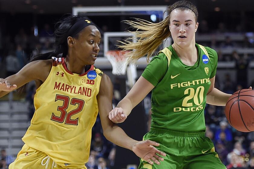 Oregon's Sabrina Ionescu, right, keeps the ball from Maryland's Shatori Walker-Kimbrough, left, during the second half of a regional semifinal game in the NCAA women's college basketball tournament, Saturday, March 25, 2017, in Bridgeport, Conn. (AP Photo/Jessica Hill)
