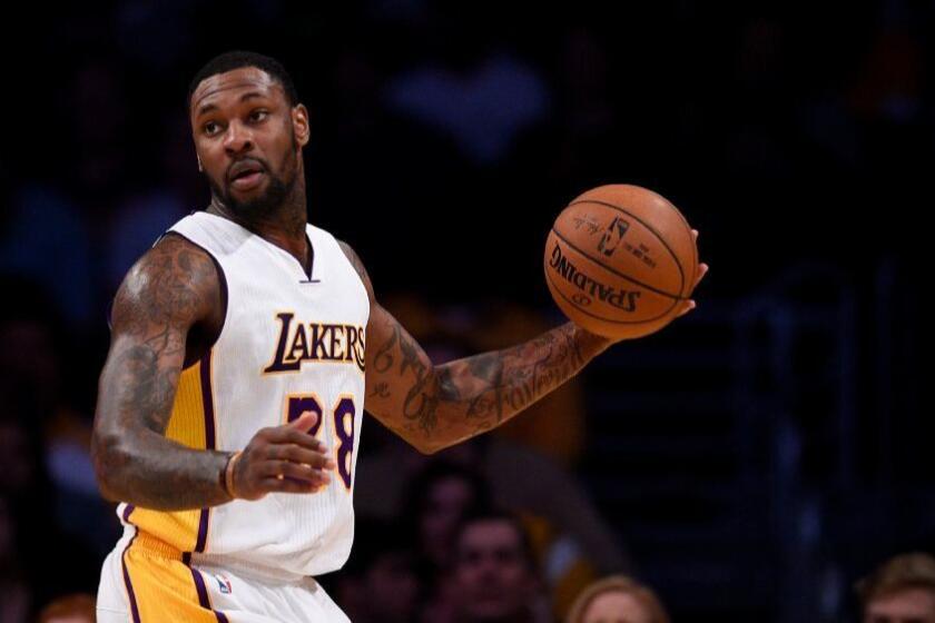 Lakers center Tarik Black looks to pass during the first half of a game against the Toronto Raptors on Jan. 1.