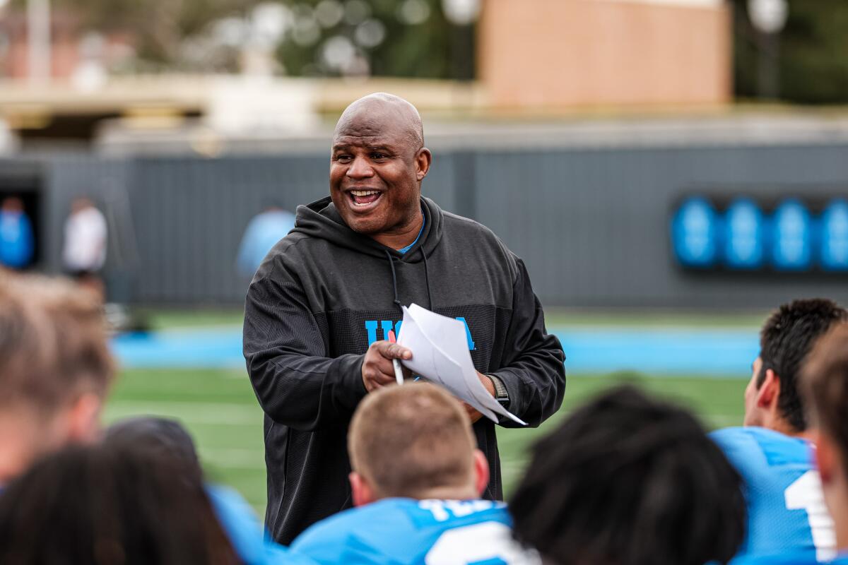 UCLA associate head coach and offensive coordinator Eric Bieniemy talks to players at spring practice.