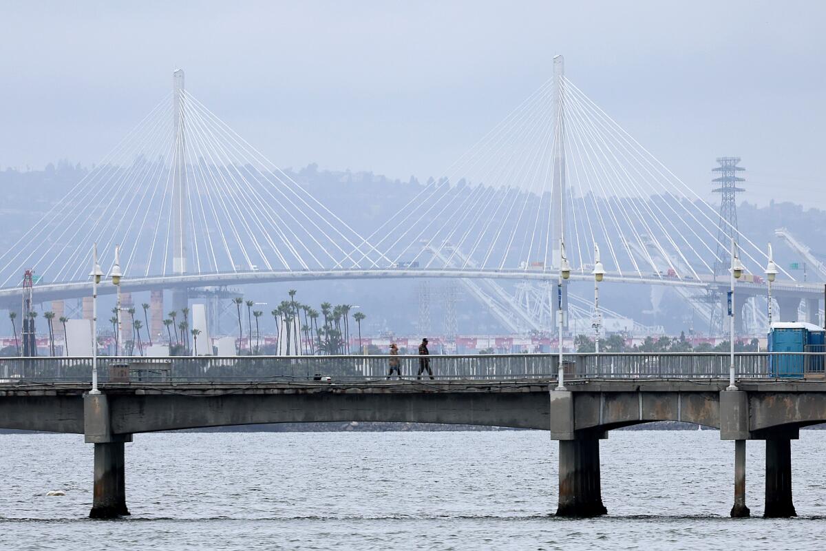 A couple walk on the Belmont Veterans Memorial Pier.