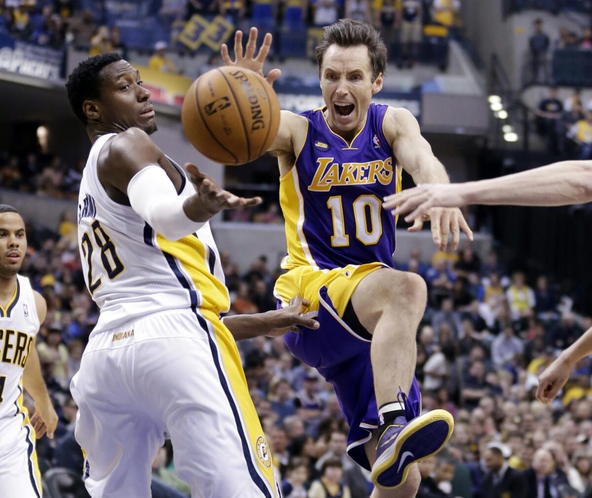 Lakers guard Steve Nash, right, loses the ball while attempting to shoot over Indiana Pacers center Ian Mahinmi.