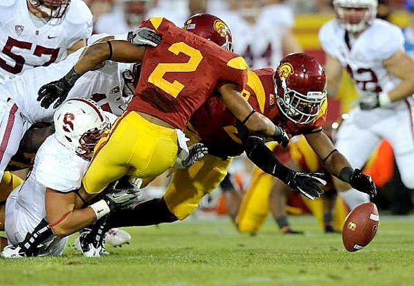 USC's Robert Woods (2) fumbles the ball on a kickoff return but teammate Jawanza Starling is there to make the recovery in the first half against Stanford on Saturday at the Coliseum.