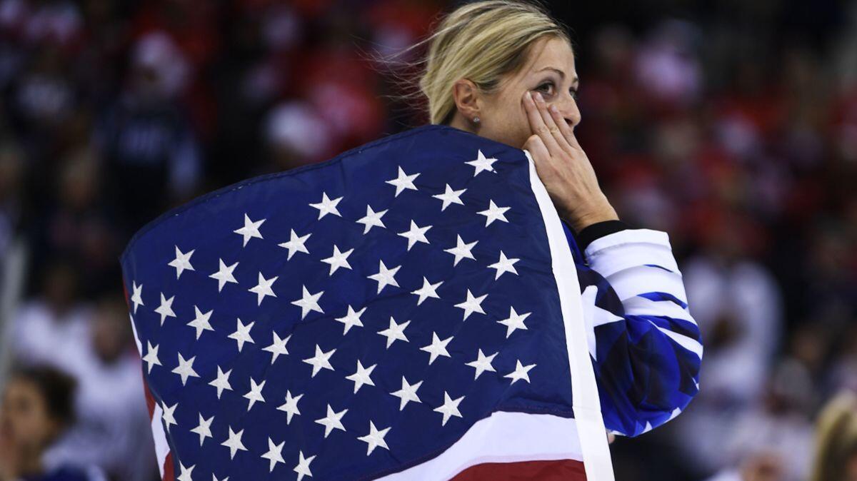 Gigi Marvin holds the U.S. flag after her team won the women's gold medal ice hockey match between the U.S. and Canada during the Pyeongchang 2018 Winter Olympic Games on Thursday.