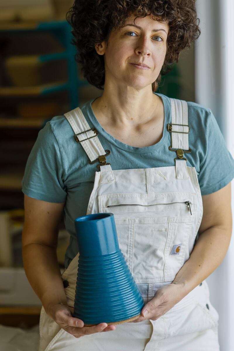 Becki Chernoff holds a ceramic vase