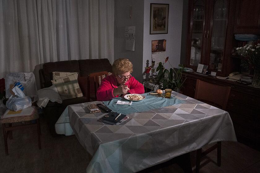 Rosa Otero, 83, eats her Christmas Eve dinner at her home in Barcelona, Spain.