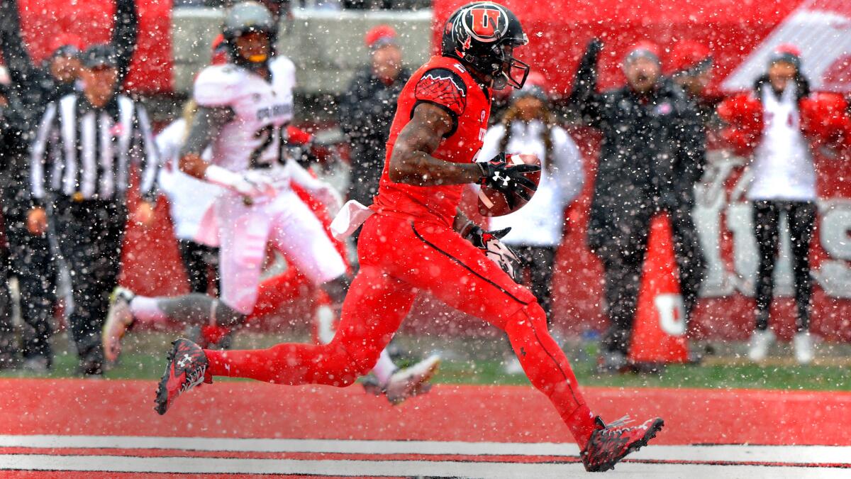 Utah wide receiver Kenneth Scott scores a touchdown against Colorado during a snowy first quarter on Nov. 28, 2015.