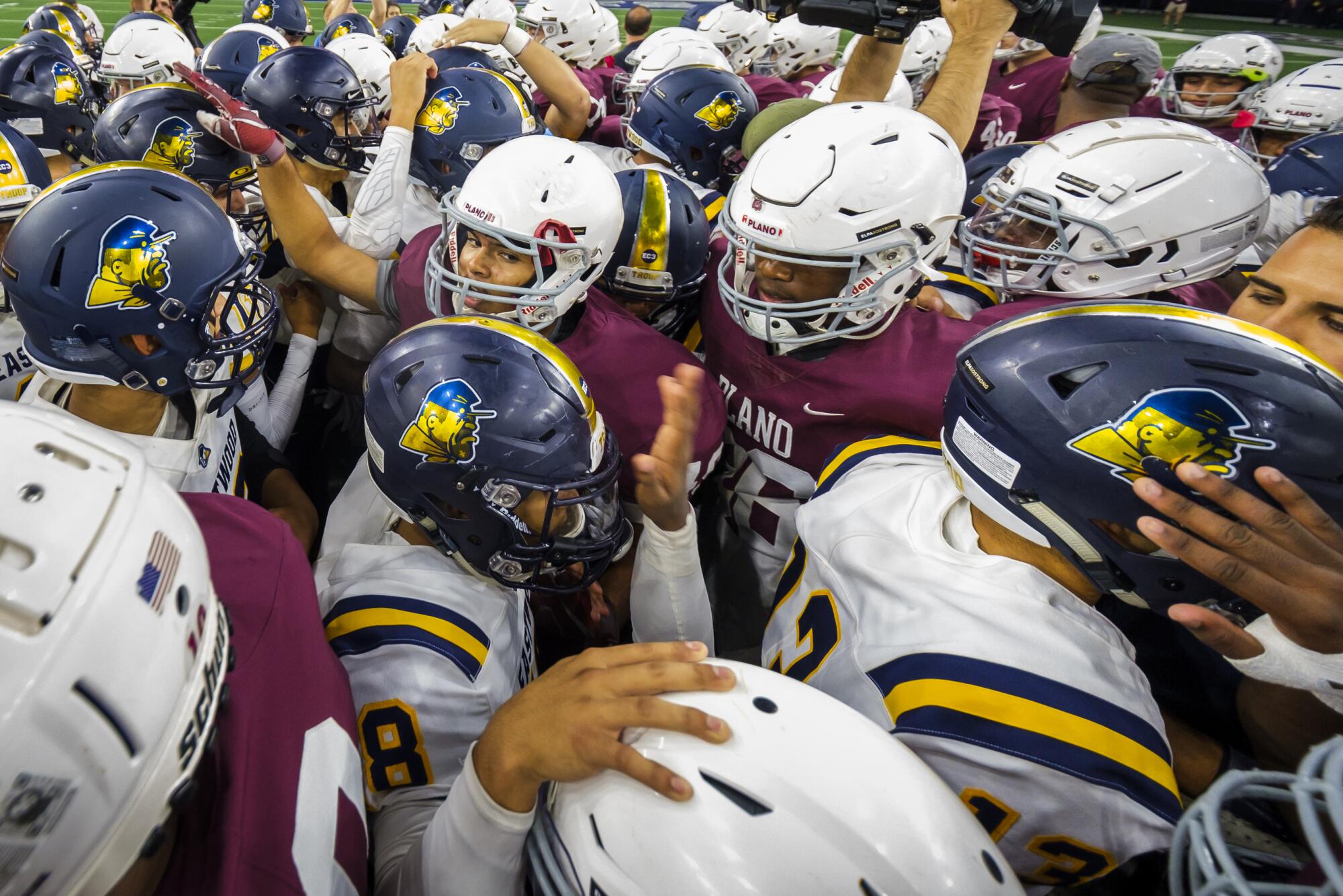 Players from Plano and El Paso Eastwood meet at midfield before their game on Sept. 5.