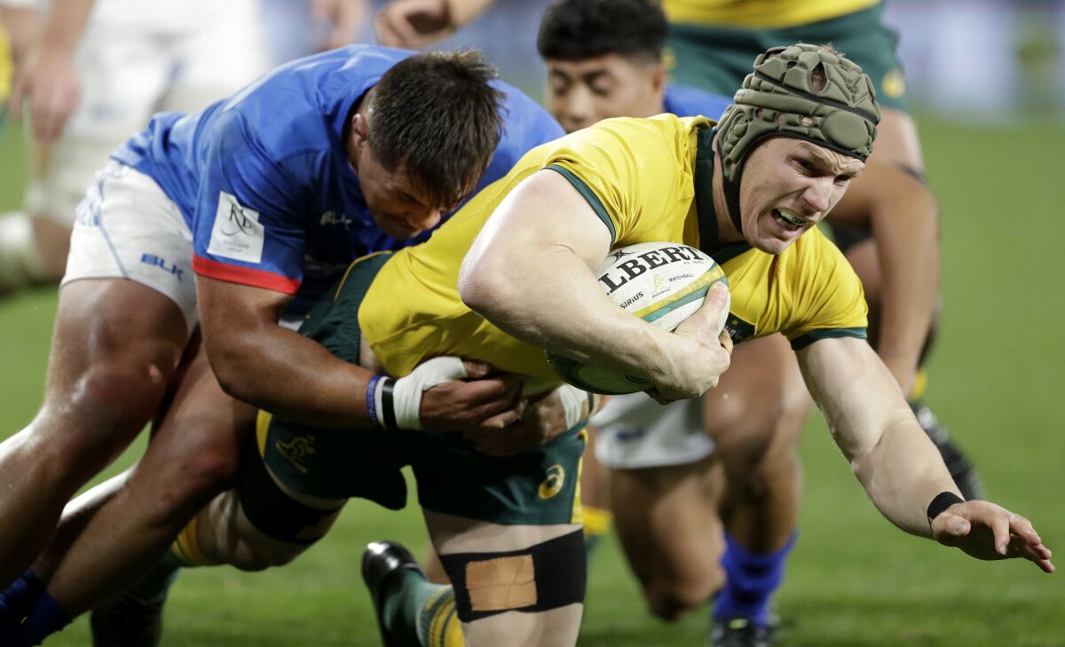 FILE - Australia's David Pocock, right, is tackled by Samoa's Jordan Lay during their rugby union test match in Sydney on Sept. 7, 2019. Election officials confirmed, Tuesday June 14, 2022 that former Wallaby Pocock has been elected as an independent senator in Australia. (AP Photo/Rick Rycroft, File)