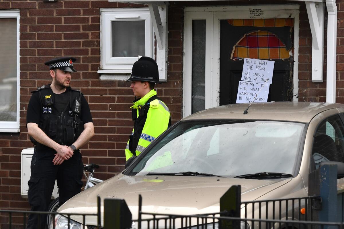 Police officers stand outside a property in Quantock Street in the Moss Side area of Manchester where a raid was carried out on May 28, 2017.