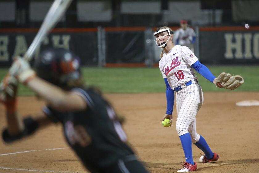 Los Alamitos pitcher Cari Ferguson (18) delivers a pitch during Sunset League girls' softball finale.