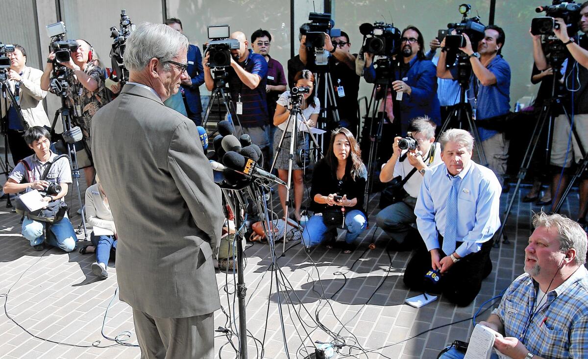Dr. Robert Kim-Farley, left, director of Communicable Disease Control and Prevention for the Los Angeles County Department of Public Health, answers reporters' questions regarding Ebola at a news conference.