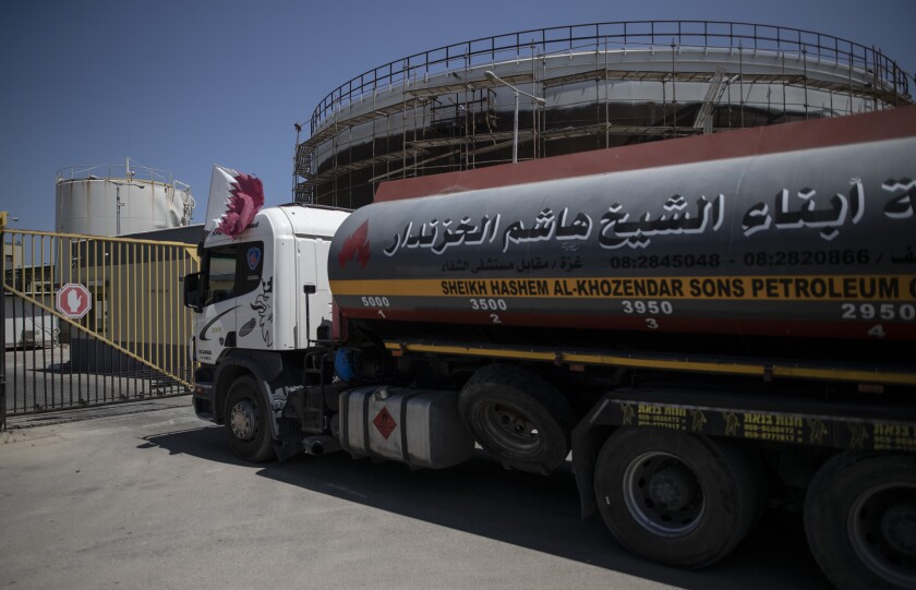 FILE - A fuel truck with a Qatari flag enters the Nusseirat power plant, in the central Gaza Strip, Monday, June 28, 2021. Gaza's Hamas rulers have reached an agreement by which Qatar will resume subsidizing the salaries of public employees by sending fuel to the impoverished territory, a Hamas official said Tuesday, Nov. 30. (AP Photo/Khalil Hamra, File)