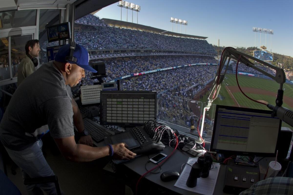 Lanier Stewart mixes music at Dodger Stadium as the Dodgers play the St. Louis Cardinals in Game 3 of the NLCS.