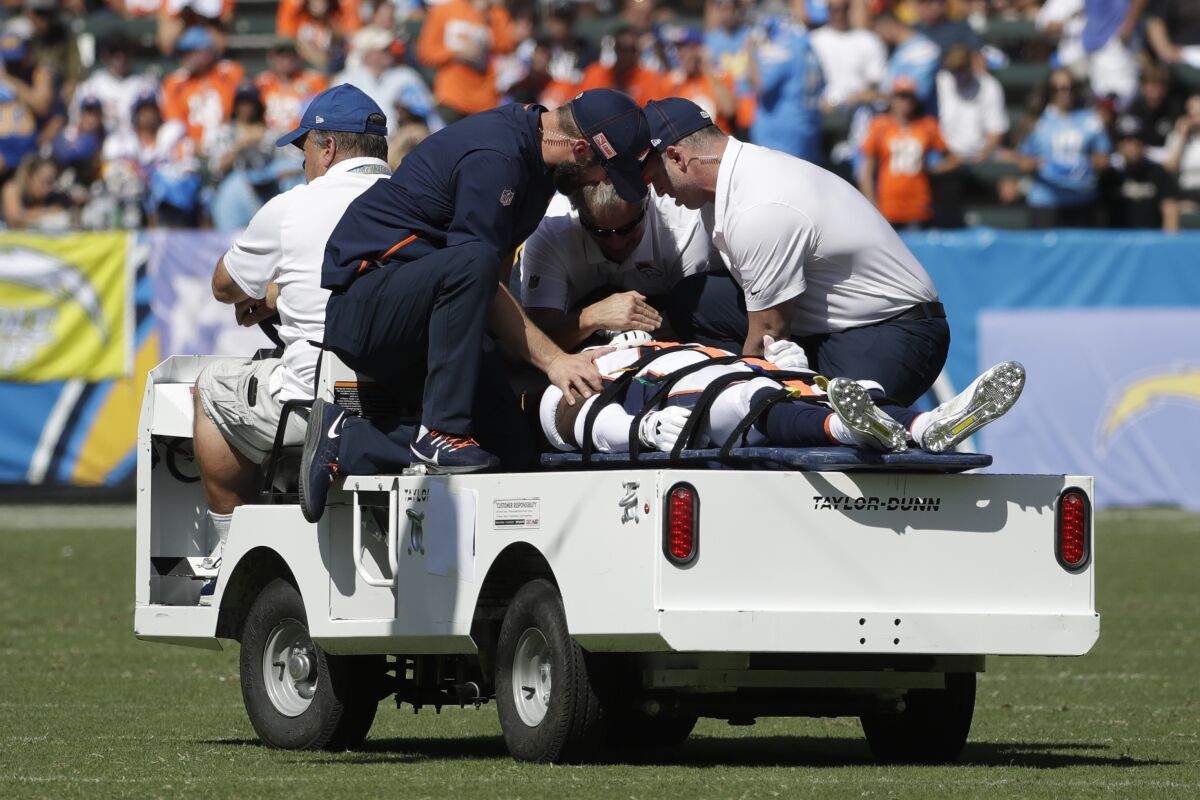 Broncos cornerback De'Vante Bausby is taken off the field after suffering an injury against the Chargers on Oct. 6, 2019.