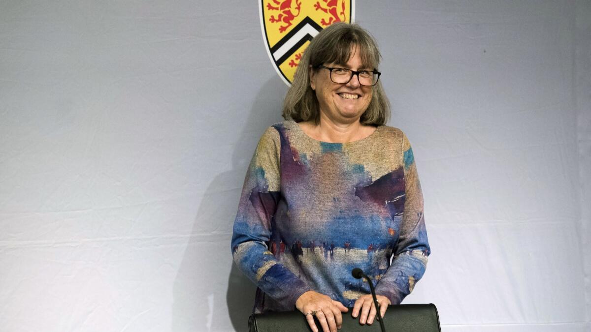 Noble Prize winner Donna Strickland smiles as she receives a standing ovation at the University of Waterloo in Canada. She is the third woman to win the physics prize.