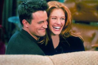 304422 21: Actor Matthew Perry and actress Julia Roberts hug each other on the set of "Friends." (Photo by Liaison)