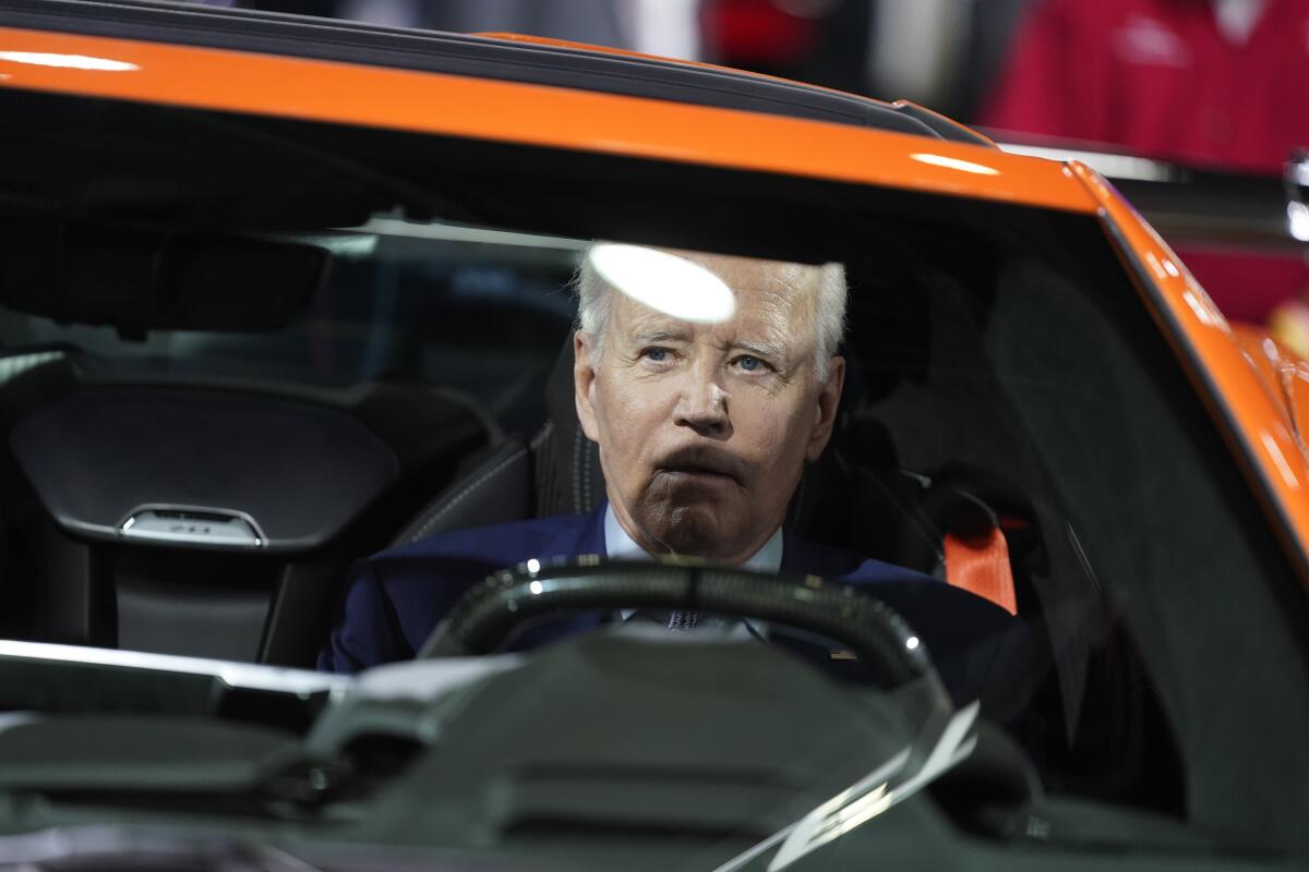 President Joe Biden sits in a Corvette during a tour of the Detroit Auto Show, Wednesday, Sept. 14, 2022, in Detroit. (AP Photo/Evan Vucci)