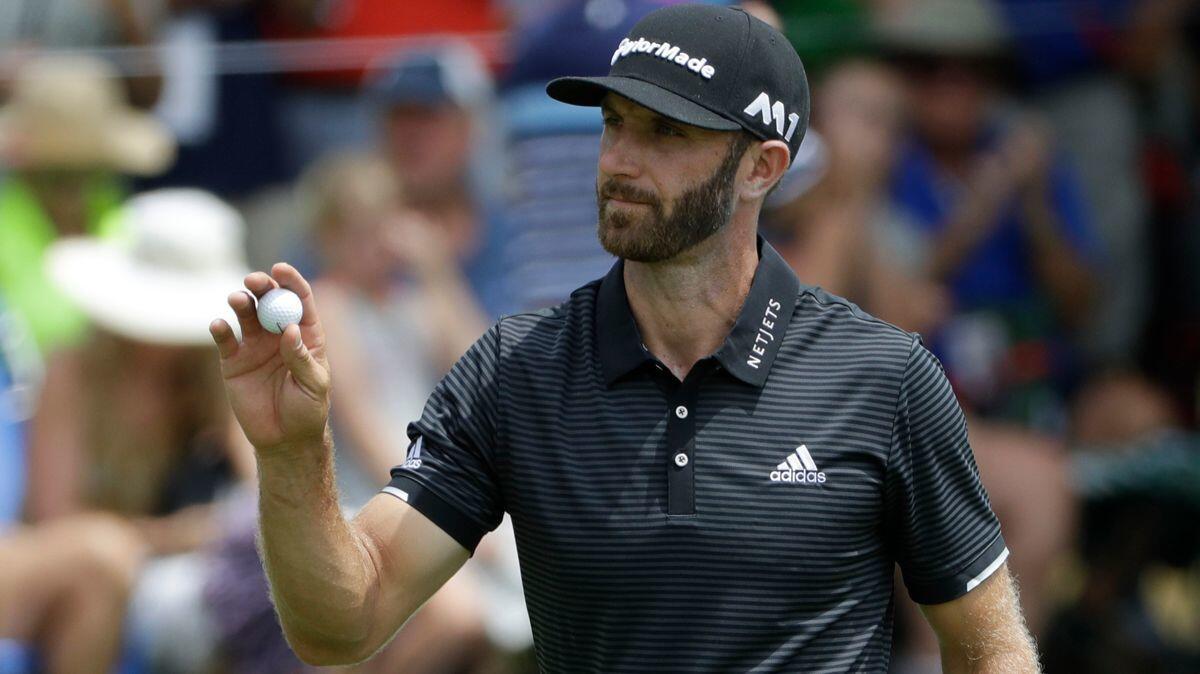 Dustin Johnson waves on the 15th hole during the final round of the PGA Championship golf tournament at the Quail Hollow Club on Sunday.