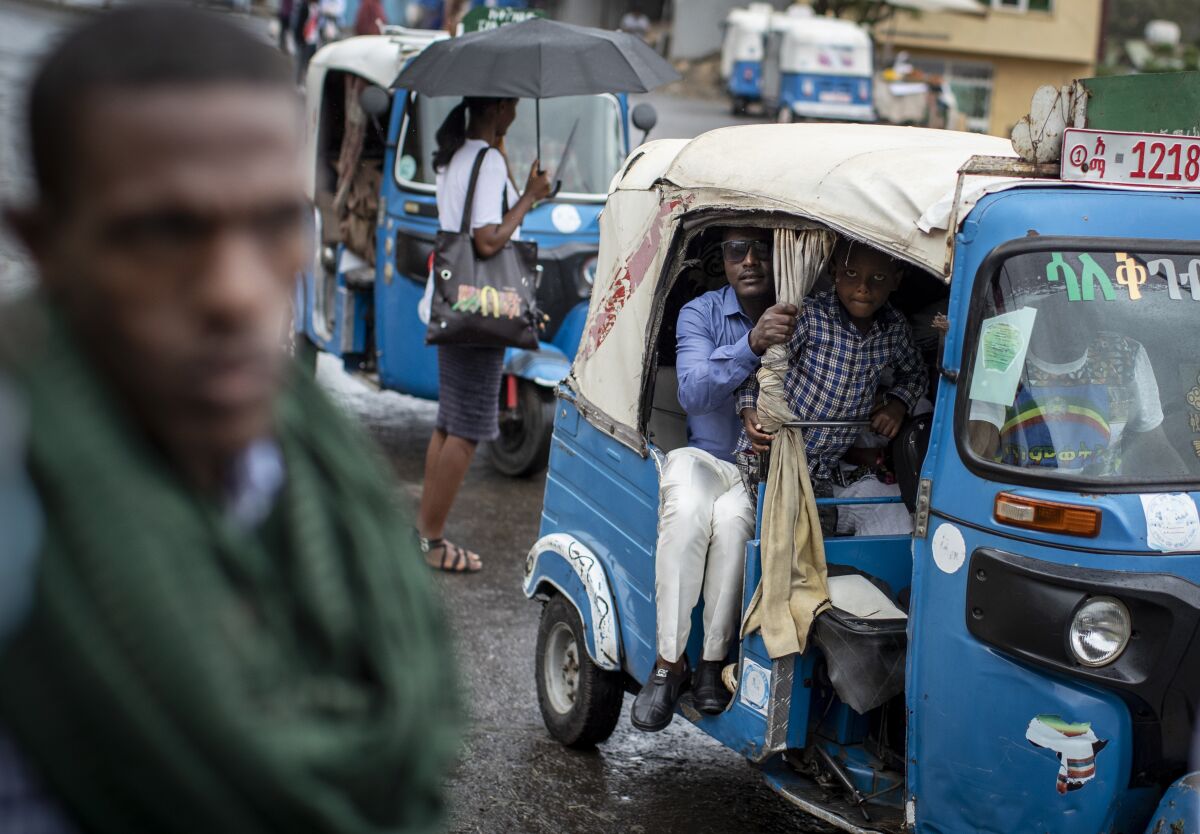 FILE - Passengers look out from an auto-rickshaw, known locally as a "bajaj", in Gondar, in the Amhara region of Ethiopia on May 2, 2021. Once a key ally of the federal government in its deadly war in the Tigray region, the neighboring Amhara region has in May 2022 experienced government-led mass arrests and disappearances of activists, journalists and other perceived critics. (AP Photo/Ben Curtis, File)