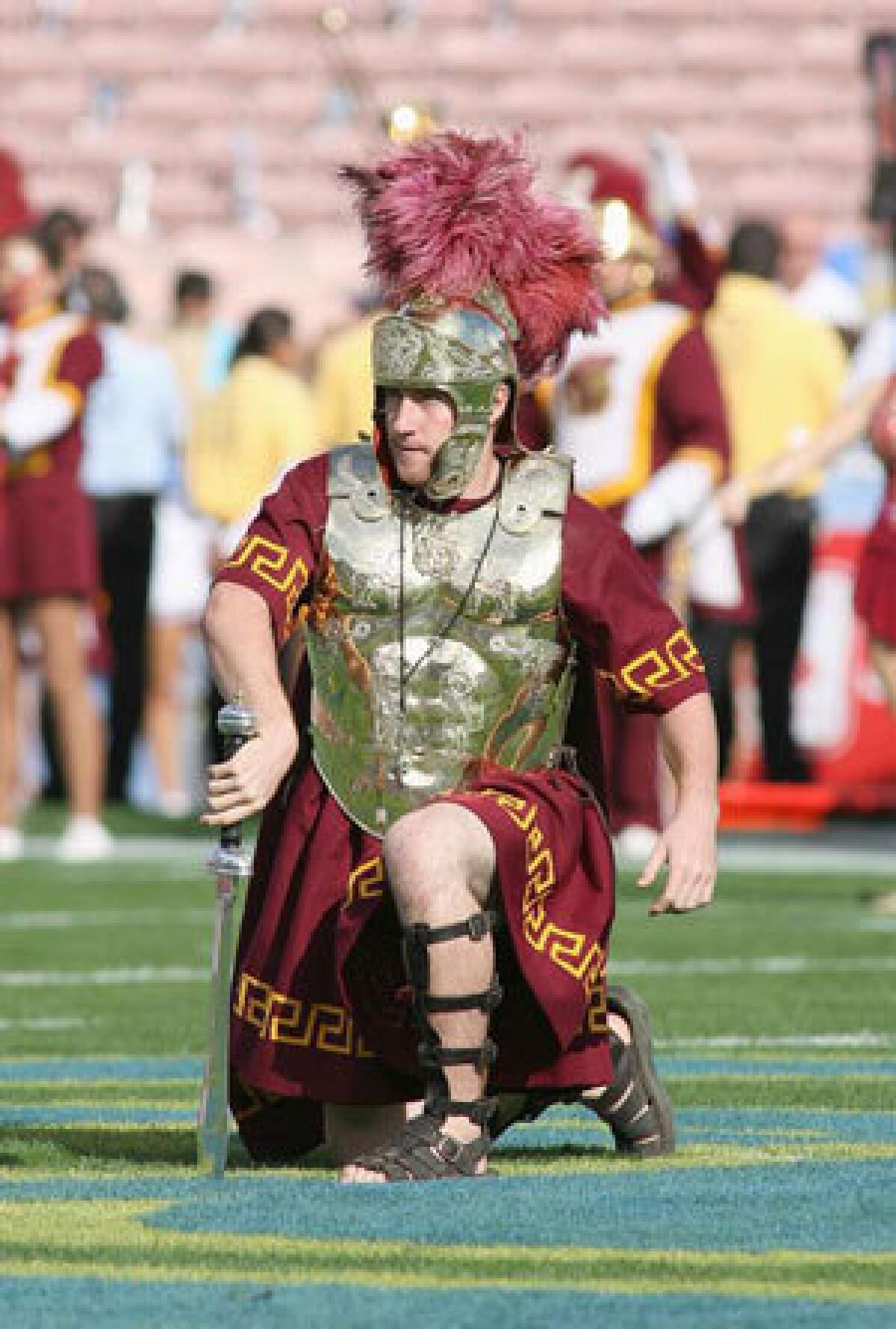 Drum major Ed Carden of USC places a sword in midfield before the game against the UCLA Bruins on Dec. 6, 2008.
