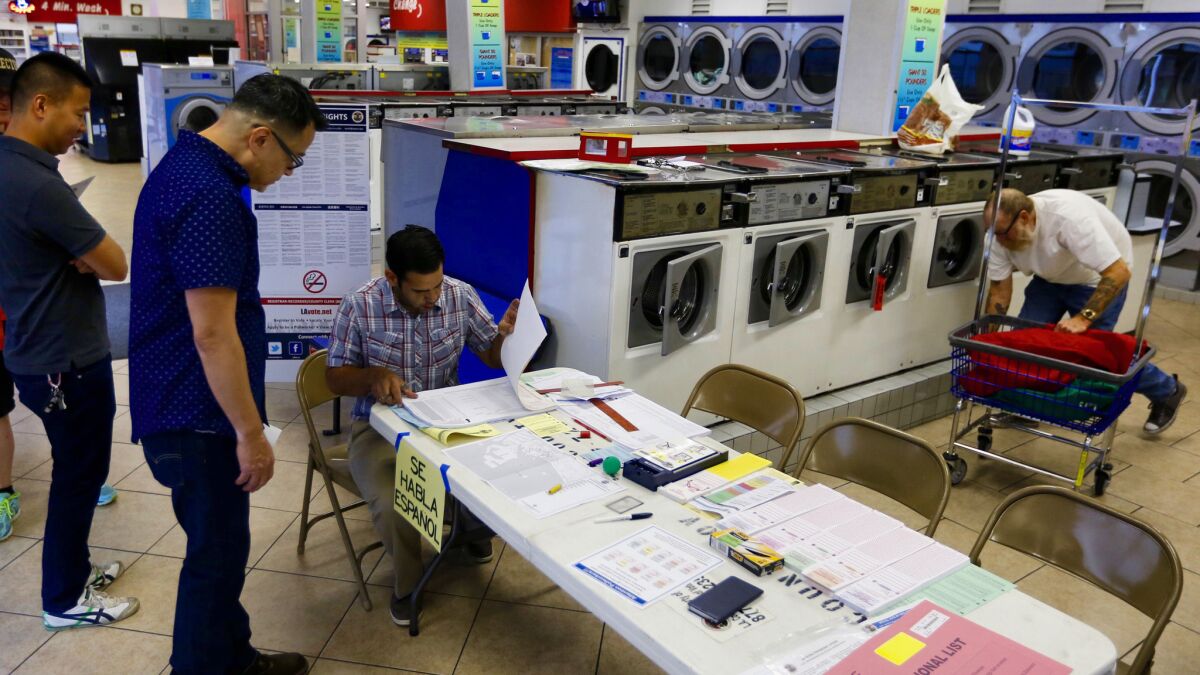 Voters line up at 7 a.m. to cast their ballots at the Super Suds Laundromat in Long Beach.