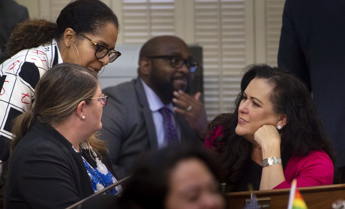 Assemblymember Lorena Gonzalez talks with other assembly members at the state Capitol in February 2020.