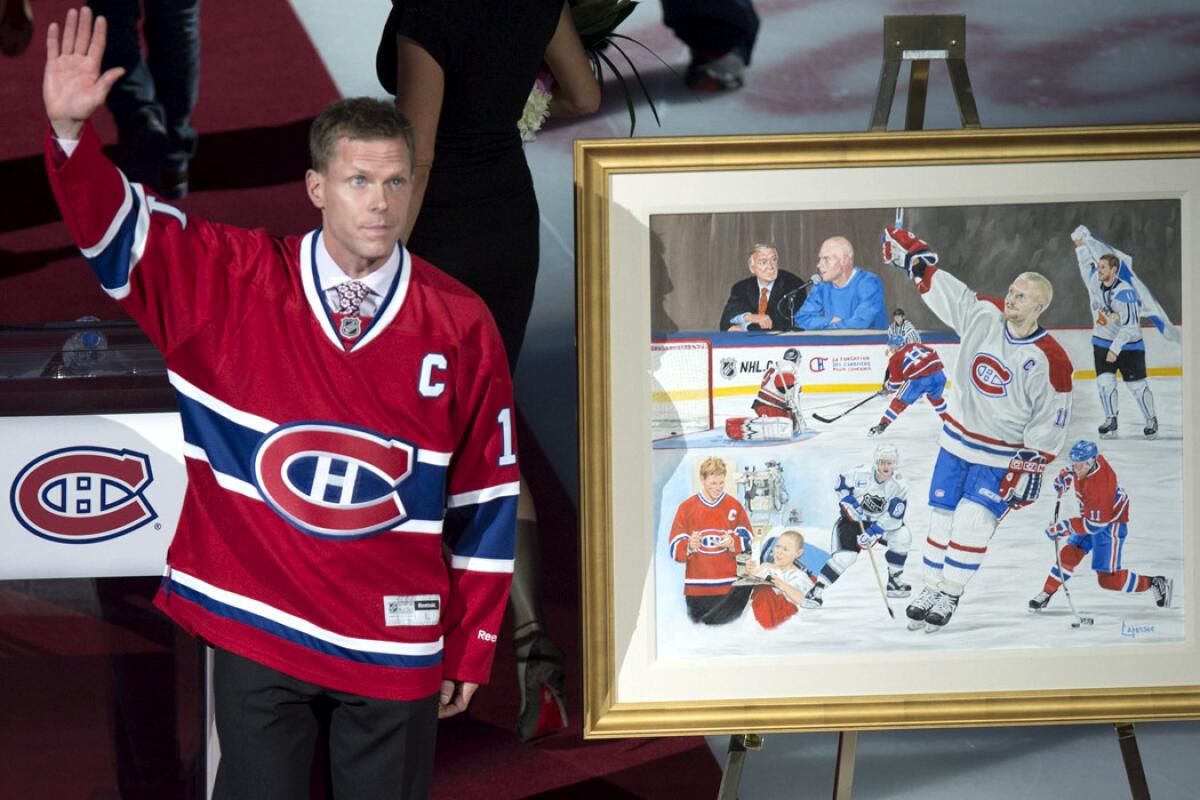 Former Canadiens captain Saku Koivu waves to the crowd during a ceremony to honor his career on Thursday night in Montreal.