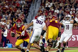 USC quarterback Caleb Williams (13) scrambles out of the pocket as Arizona defensive lineman Isaiah Ward rushes 