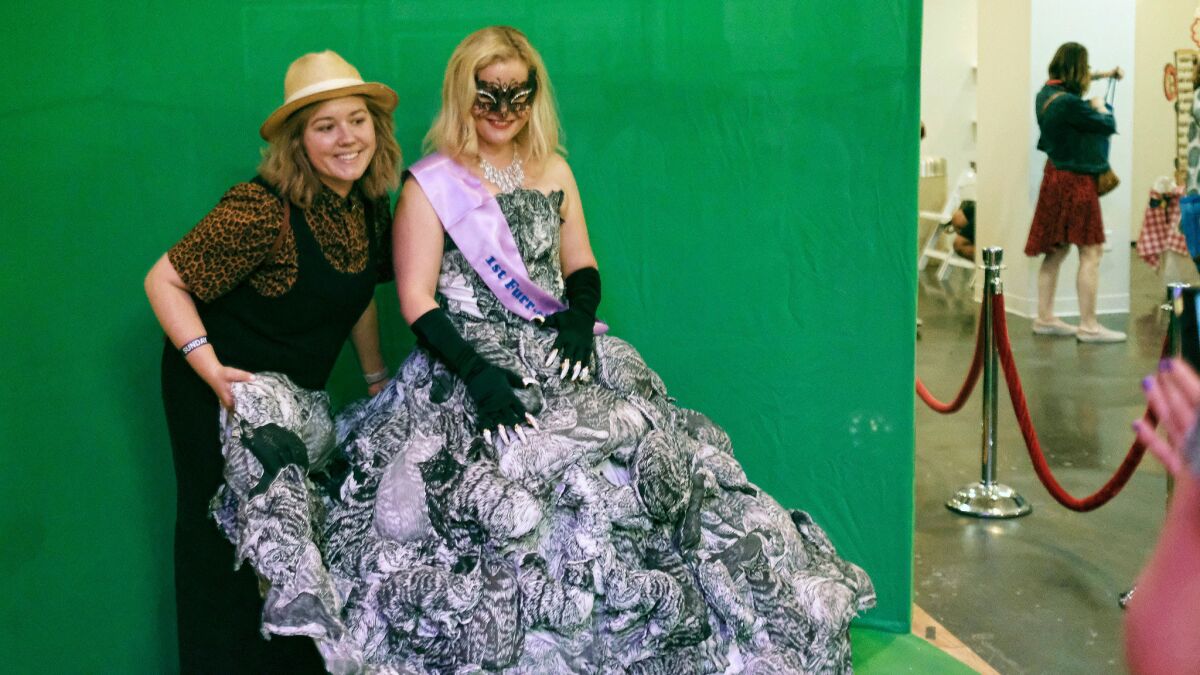 Laura Mart, right, poses for a photo with her fashion cat assistant Cate Thurston at CatCon LA in Los Angeles.