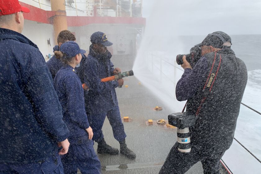 Los Angeles Times photographer Brian van der Brug gets soaked April 20 while shooting Coast Guard crew members training for firefighting aboard the Polar Star, the lone U.S. heavy icebreaker. Van der Brug and reporter Richard Read rode the dilapidated ship from Seattle to Vallejo, Calif., for a Column 1 story reconstructing its most recent voyage to Antarctica and back.
