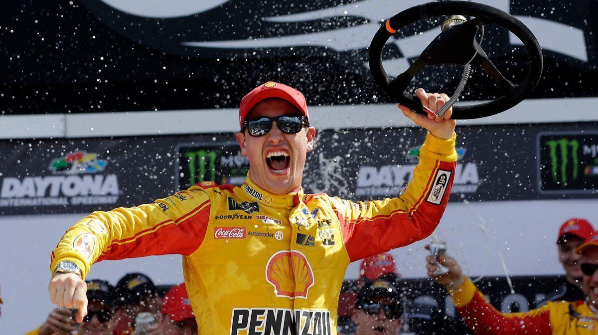 Joey Logano celebrates in Victory Lane after winning the NASCAR Clash auto race at Daytona International Speedway on Sunday.