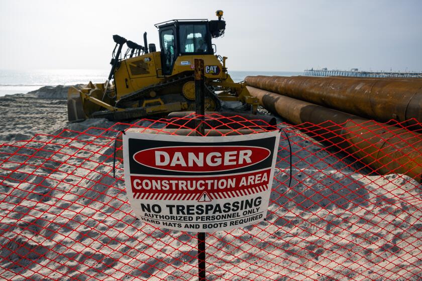 San Clemente, CA - December 27: Heavy equipment on the beach south of the pier on Wednesday, Dec. 27, 2023, in San Clemente, CA. A project partnership agreement for the San Clemente Shoreline Protection Project was signed between the city, the federal government, and the U.S. Army Corps of Engineers, marking a major milestone for the long-awaited sand project. Plans have been in the works for two decades to add sand to an eroding stretch of the quaint beach town. (Francine Orr / Los Angeles Times)