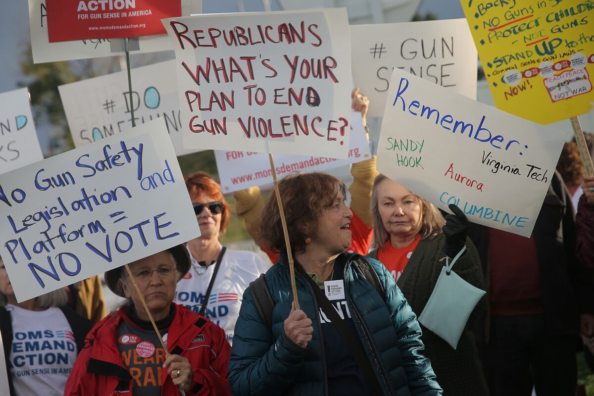 Activists in support of stricter gun laws protest outside the CNBC Republican Presidential Debate on Oct. 28 in Boulder, Colo.