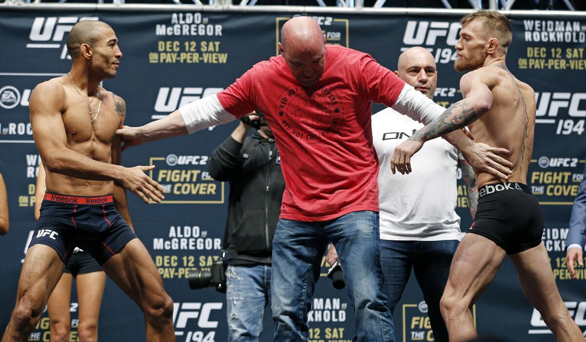 UFC president Dana White, center, stands between Conor McGregor, right, and Jose Aldo during the weigh-in for UFC 194 on Friday in Las Vegas.