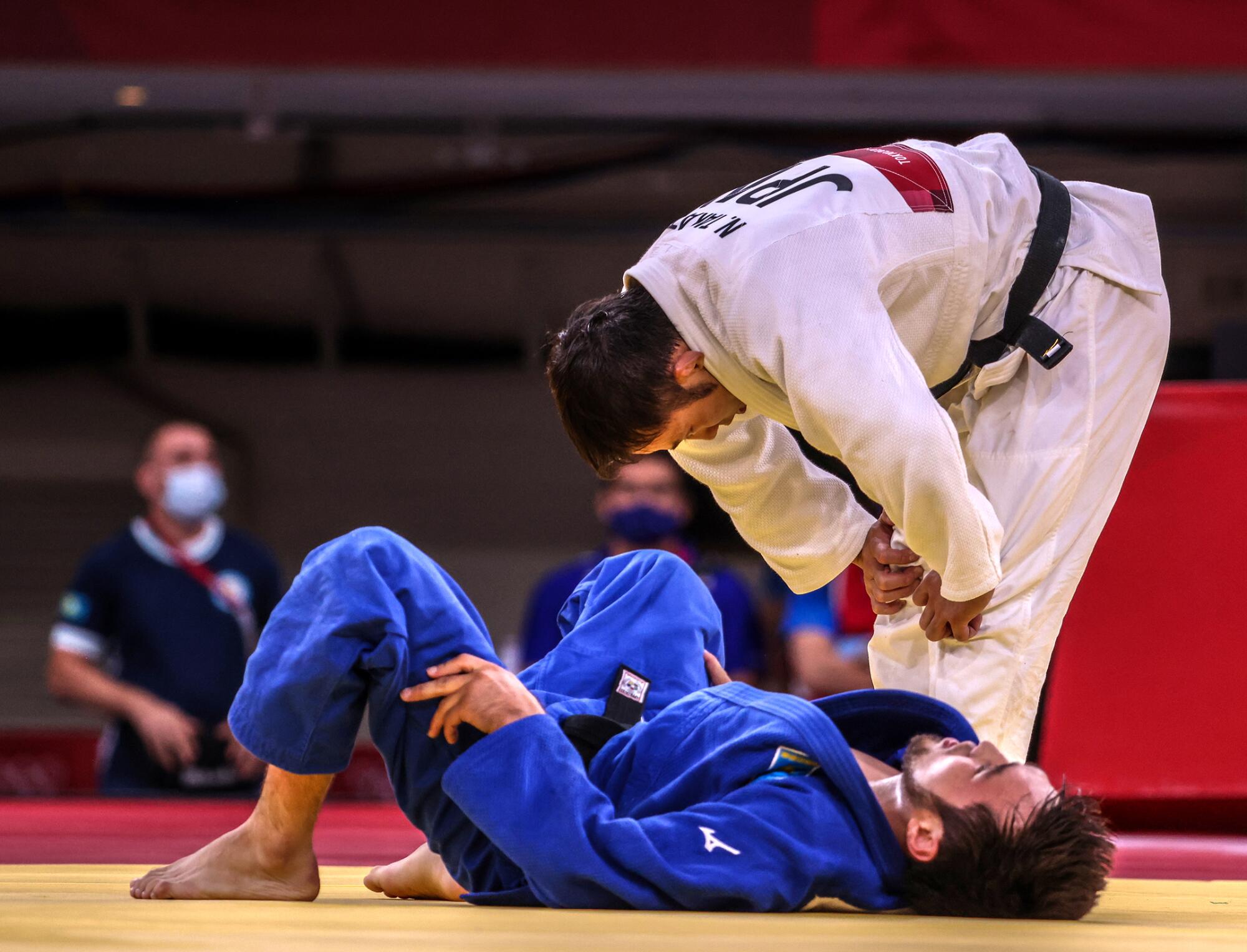 Japan's Naohisa Takato defeats Yeldos Smetov of Kazakhstan.
