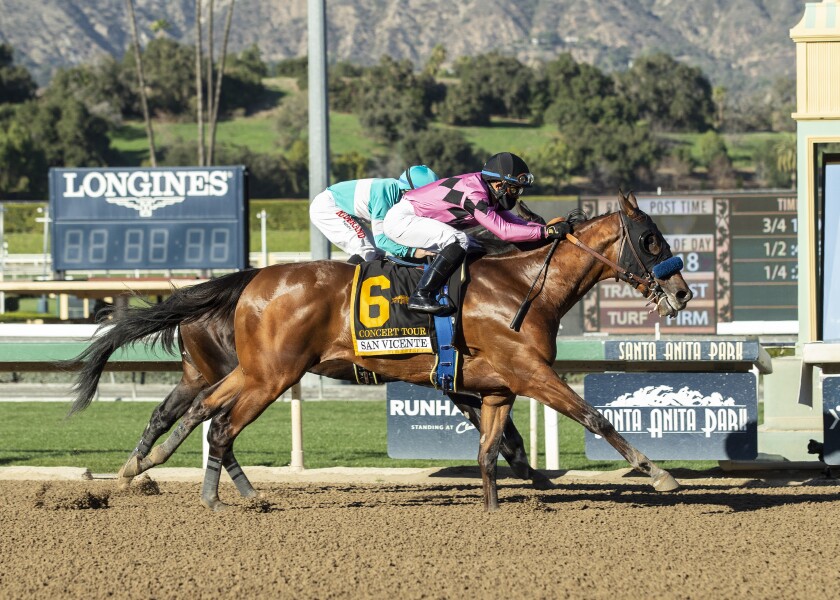 In this image provided by Benoit Photo, Concert Tour (6) and jockey Joel Rosario, cross the finish line ahead of Freedom Fighter, rear, and Drayden Van Dyke, to win the Grade II $200,000 San Vicente Stakes horse race, Saturday, Feb. 6, 2021 at Santa Anita Park, in Arcadia, Calif. (Benoit Photo via AP)