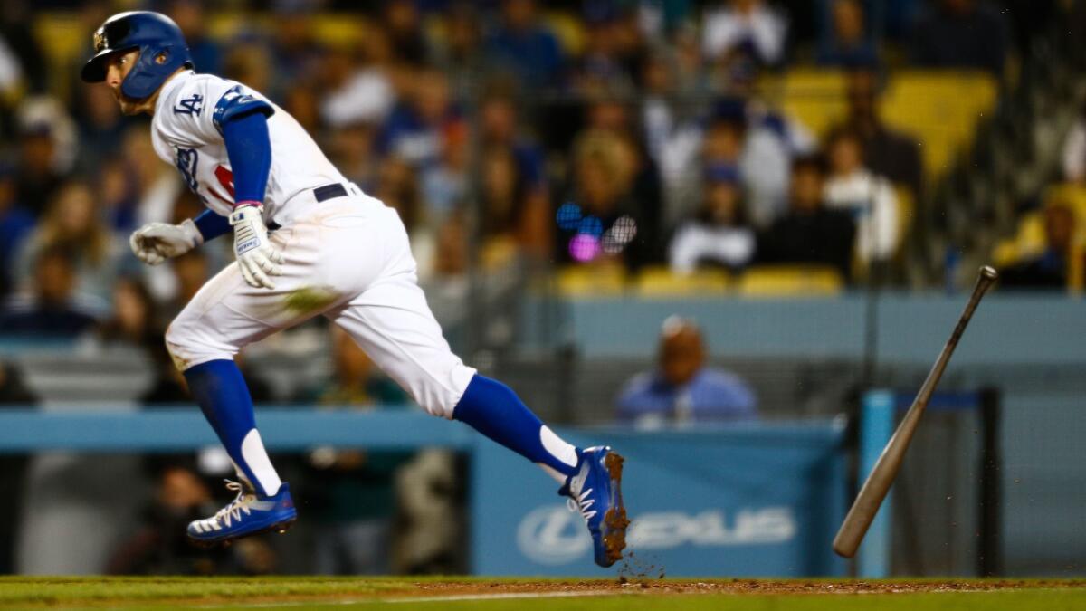 Dodgers center fielder Enrique Hernandez runs to first base after getting a hit off San Francisco pitcher Madison Bumgarner.