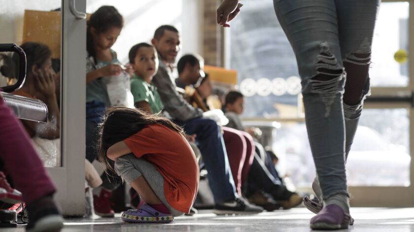 Immigrant detainees wait at a bus terminal in McAllen, Texas.