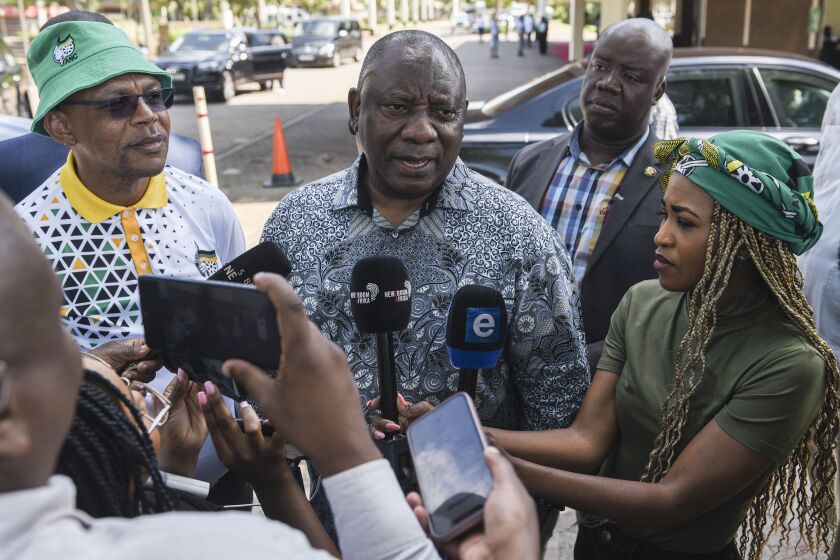 South African President Cyril Ramaphosa speaks to the media after leaving an African National Congress (ANC) National Executive Committee meeting in Johannesburg, Sunday, Dec. 4, 2022. The meeting is being held to discuss the future of Ramaphosa as calls continue for his resignation over a scandal over money stolen from his farm. (AP Photo)