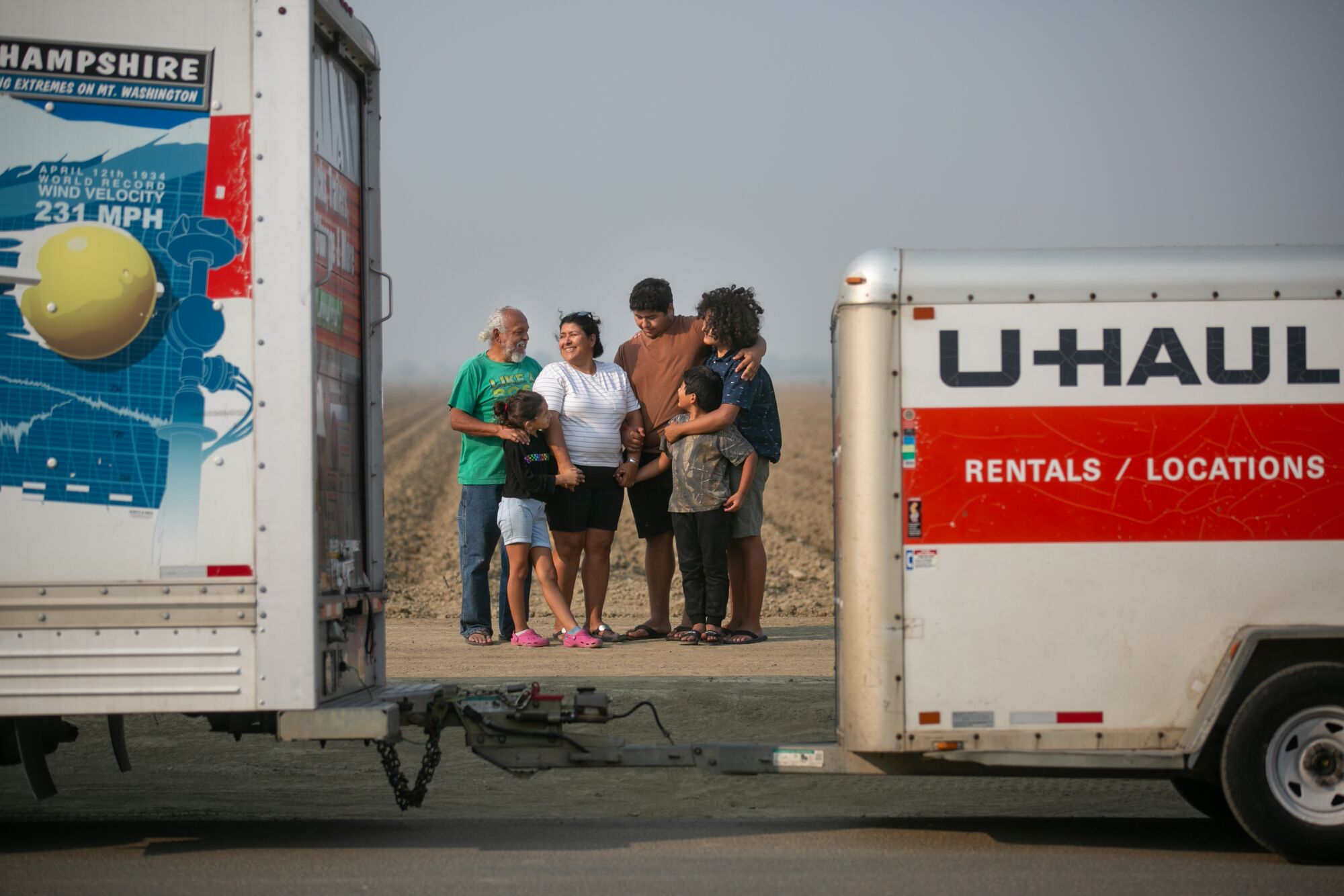 The family gathers for a photo by their U-Haul