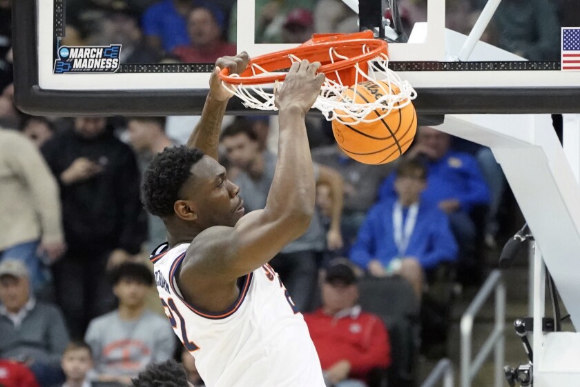 FILE - Illinois' Kofi Cockburn dunks against Chattanooga during the first half of a college basketball game in the first round of the NCAA tournament, Friday, March 18, 2022, in Pittsburgh. Illinois All-America center Kofi Cockburn has declared for the NBA draft and hired an agent, marking the end of one of the most productive careers in program history. Cockburn made the announcement on his social media channels Wednesday, April 20, 2022, and the Illinois athletic department confirmed it. (AP Photo/Keith Srakocic, File)