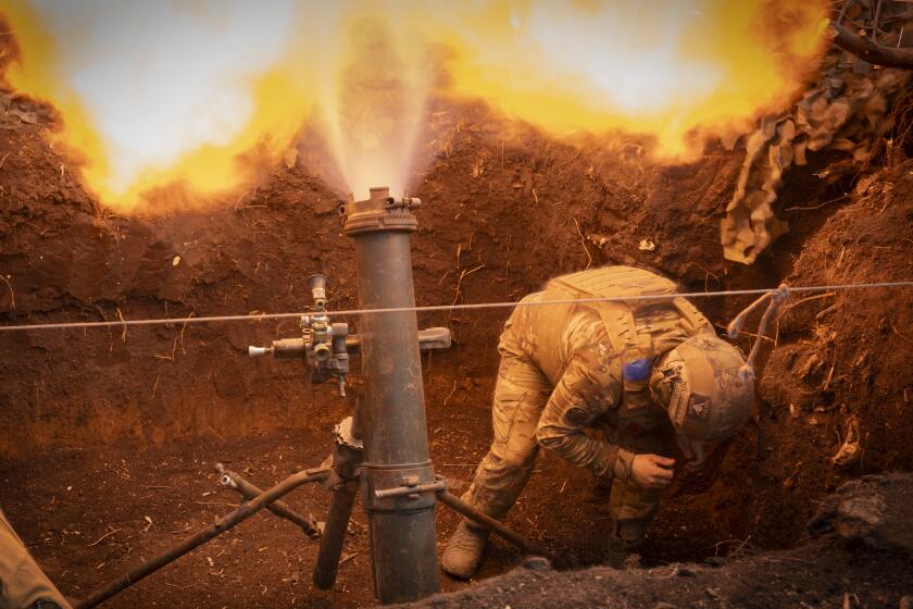 Ukrainian servicemen of the 28th Separate Mechanised Brigade fires a 122mm mortar towards Russian positions at the front line, near Bakhmut, Donetsk region, Ukraine, Sunday, March 3, 2024. (AP Photo/Efrem Lukatsky)